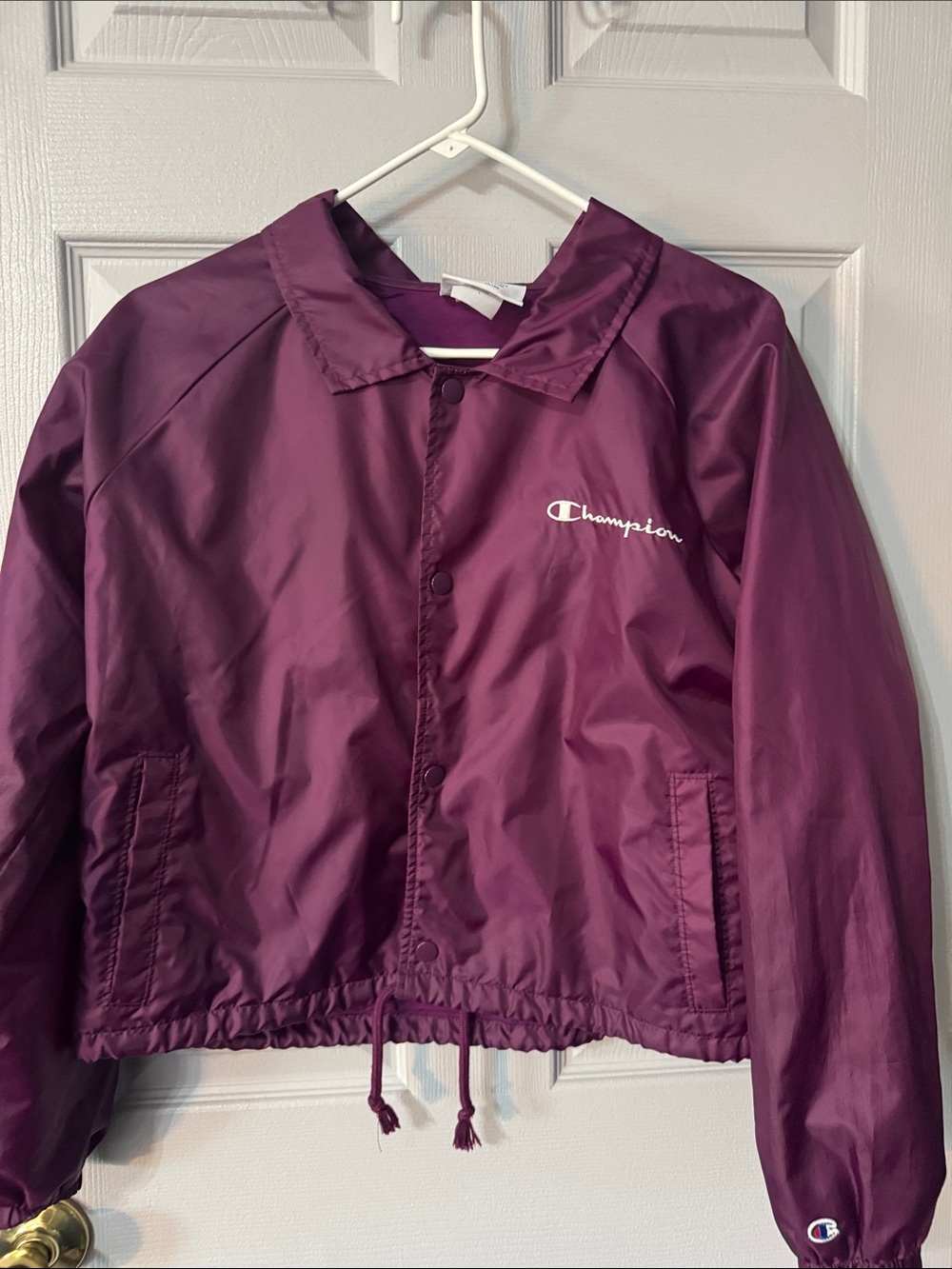 Champion Women's Heritage Coaches Jacket featuring a white script logo on